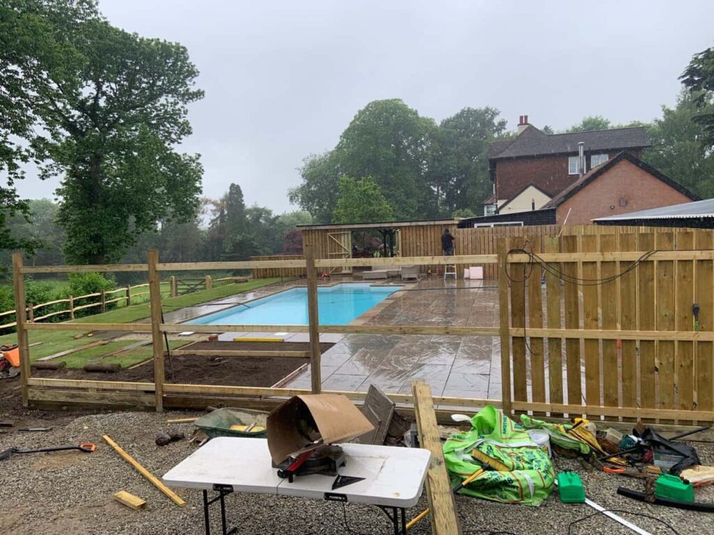 This is a photo of Bespoke custom fencing installed around a swimming pool by Sevenoaks Fencing Services